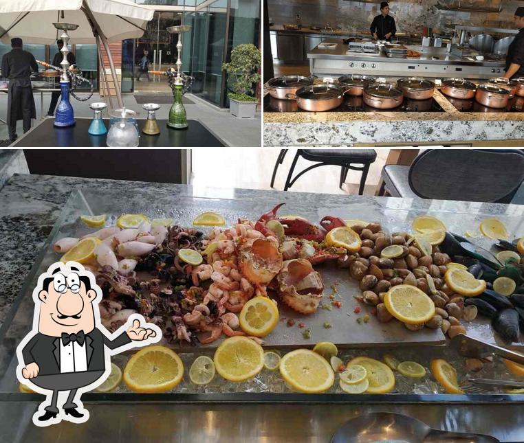 Take a seat at one of the tables at The Creek - The Den Bengaluru