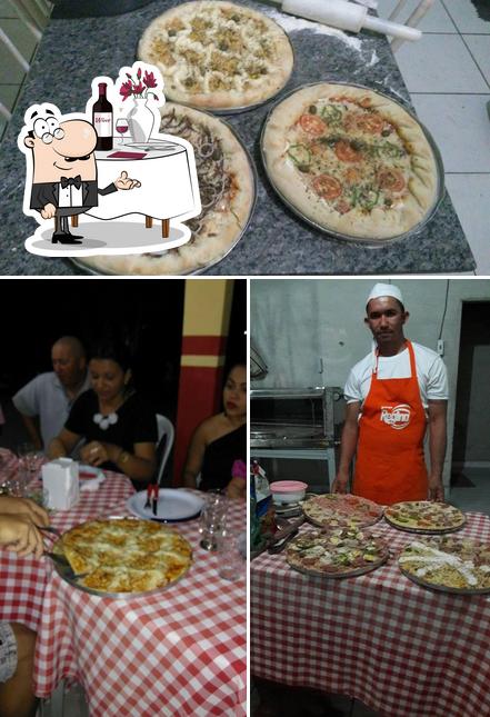 Confira a imagem apresentando mesa de jantar e pizza a Ponto Da Pizza