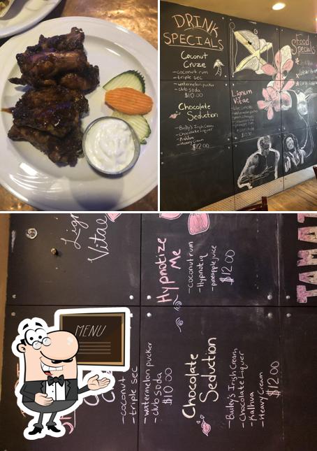Фотография, на которой видны доска для меню и еда в Caribbean Spice Cafe