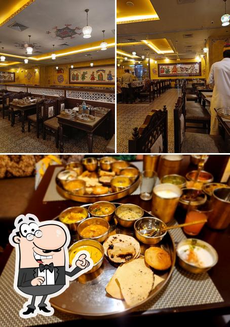 This is the image showing interior and food at Ghoomar Traditional Thali Restaurants - Amanora Mall