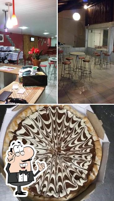 Dê uma olhada a imagem ilustrando interior e bolo no Pizzas tem tem