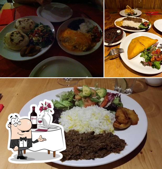 Check out the image showing dining table and food at Sabor Criollo