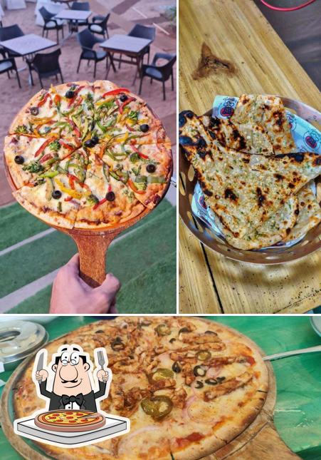 Get pizza at Tomatoes Beachside Restaurant