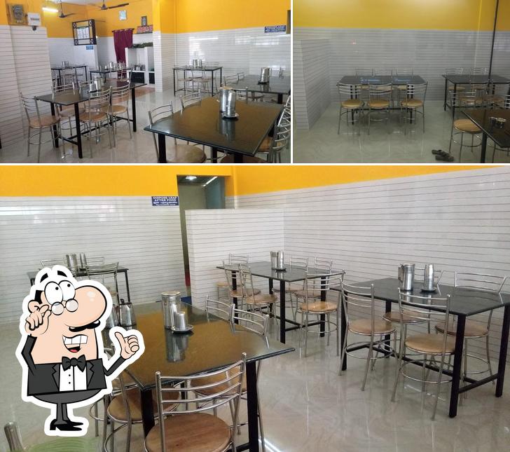 Take a seat at one of the tables at Hotel Udupi Kitchen