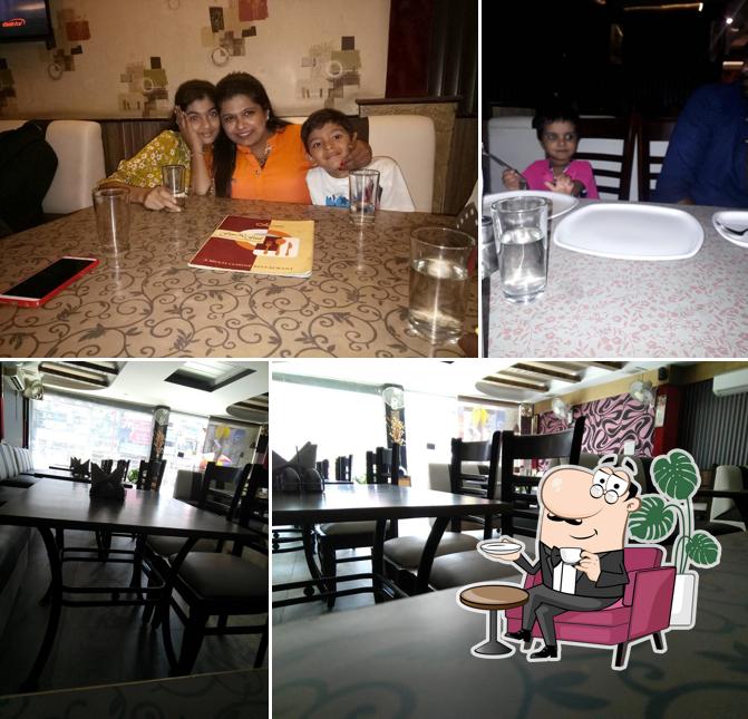 Take a seat at one of the tables at Fun N Food Restaurant
