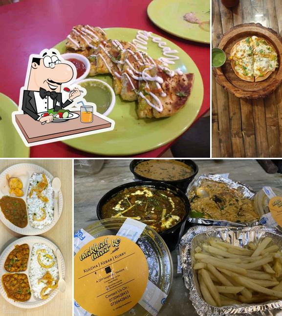 Take a look at the photo displaying food and dining table at Makhan Maar Ke