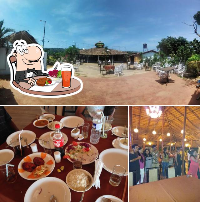 The picture of dining table and exterior at 3 Stooges Goa