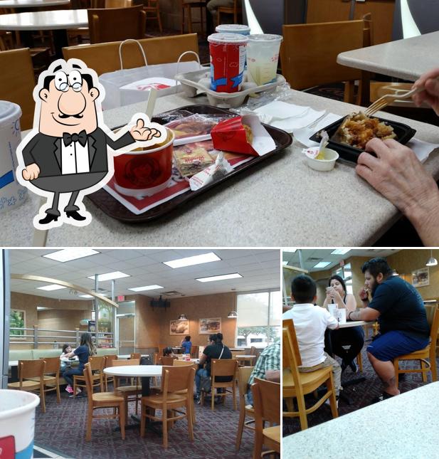 Take a look at the photo displaying interior and dining table at Wendy's