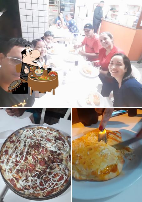 Entre diferentes coisas, comida e interior podem ser encontrados no Pizzaria Sabor a mais