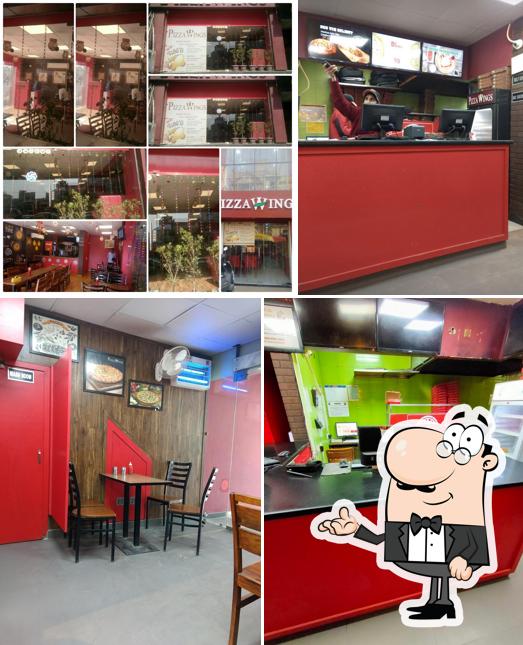 Take a seat at one of the tables at Pizza Wings Hisar