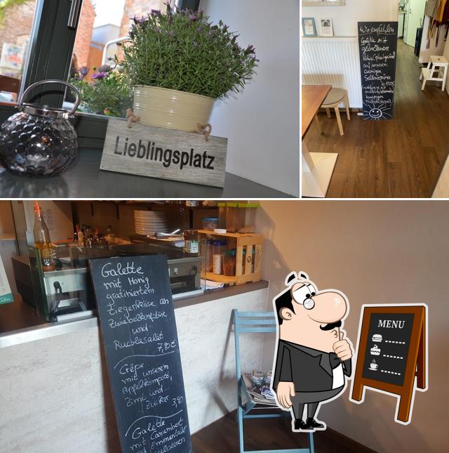 Check out the image depicting blackboard and interior at Cado's Café & Crêperie