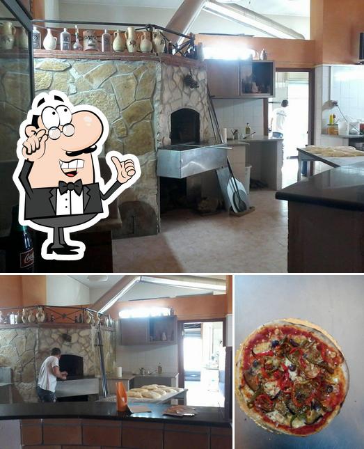 La immagine di interni e pizza da Pizzeria la trinacria