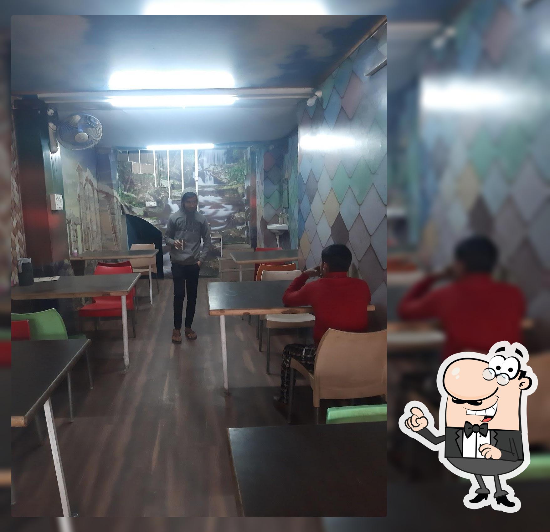 Take a seat at one of the tables at Maharaj cafe and bhojnalaya