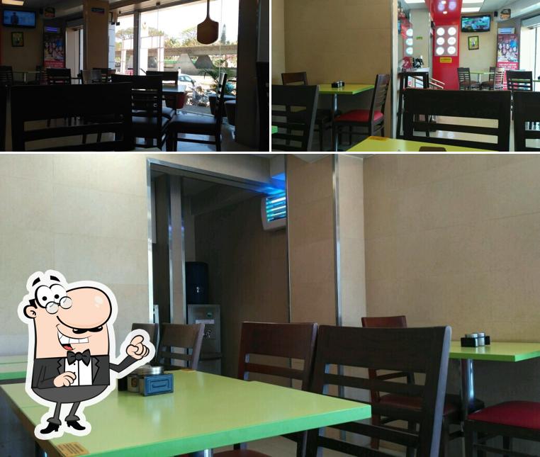 Take a seat at one of the tables at Domino's Pizza Vidya Nagar, Hubli