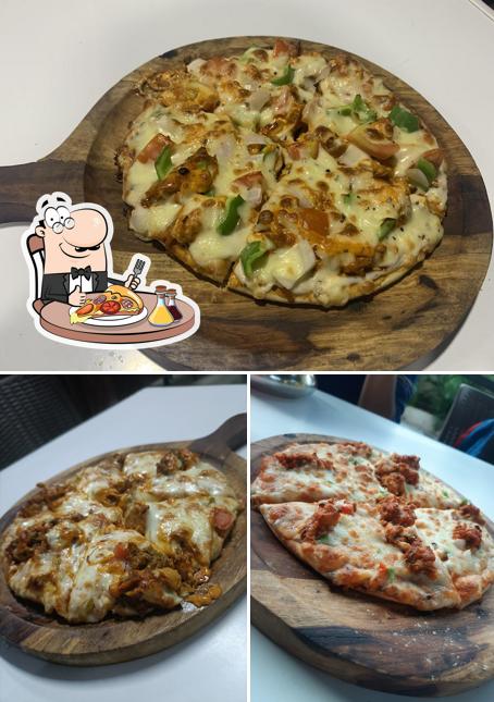 Get pizza at Crazy Rolls Cafe & Snacks