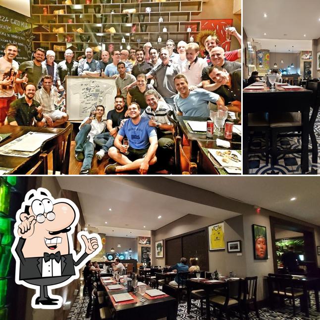 Sente em uma das mesas no Gato Mia Pizzaria