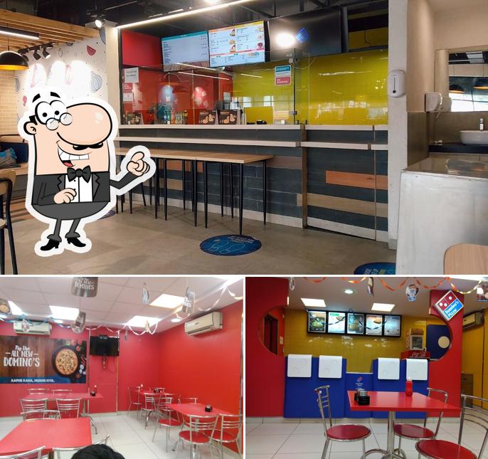Take a seat at one of the tables at Domino's Pizza Paras Society, Jamnagar