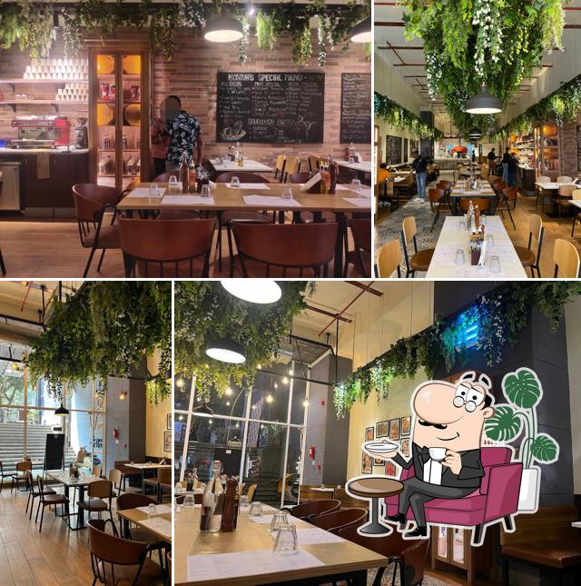Take a seat at one of the tables at Si Nonna's - The Original Sourdough Pizza - FC Road, Pune