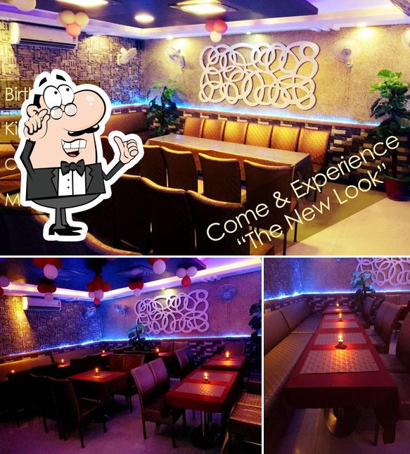 Take a seat at one of the tables at Payal Foods & Restaurant