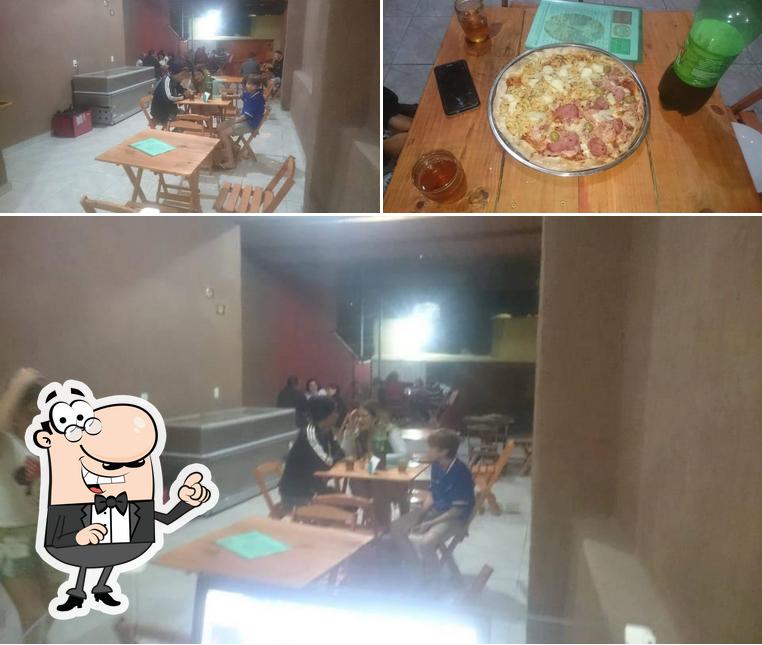 Dê uma olhada a foto mostrando interior e pizza a Pizzágora