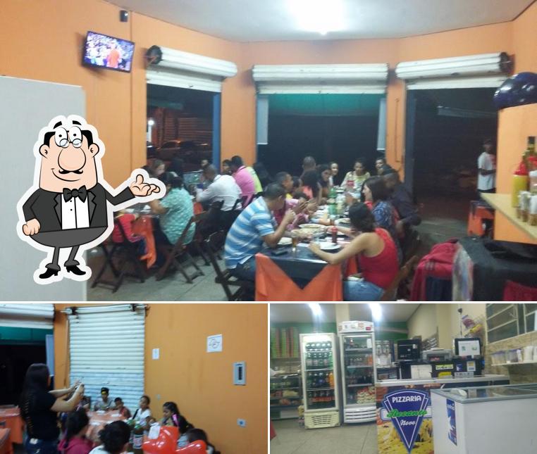 Sente em uma das mesas no Pizzaria Recanto Novo