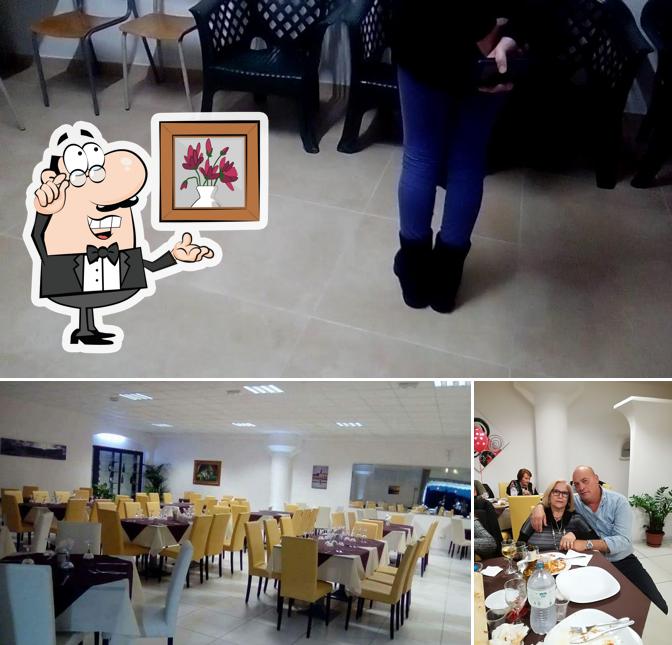 La immagine di interni e tavolo da pranzo da Pizzeria Exclusive