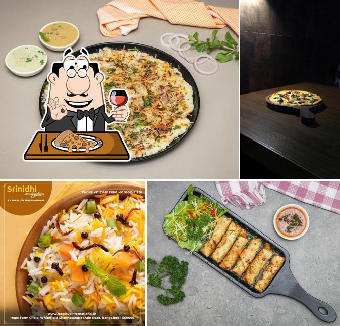 Get pizza at Srinidhi Signature Restaurant by Hotel Foxglove International