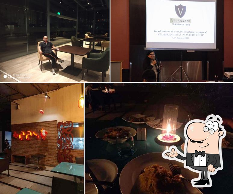 Take a seat at one of the tables at East Restaurant - Pan-Asian Rooftop