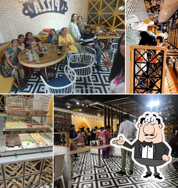 Take a seat at one of the tables at Papa Louie's Pizza Gandhidham