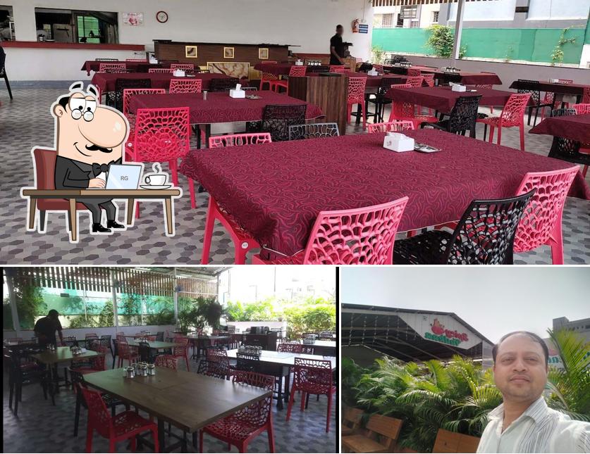 Take a seat at one of the tables at Hotel Spicy Tadkaa