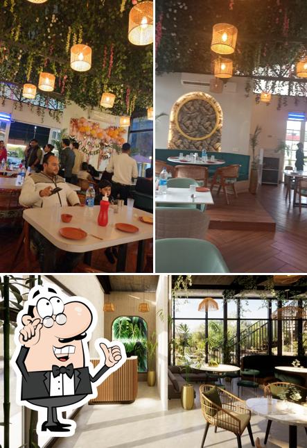 Take a seat at one of the tables at Tropical Cafe & Restro