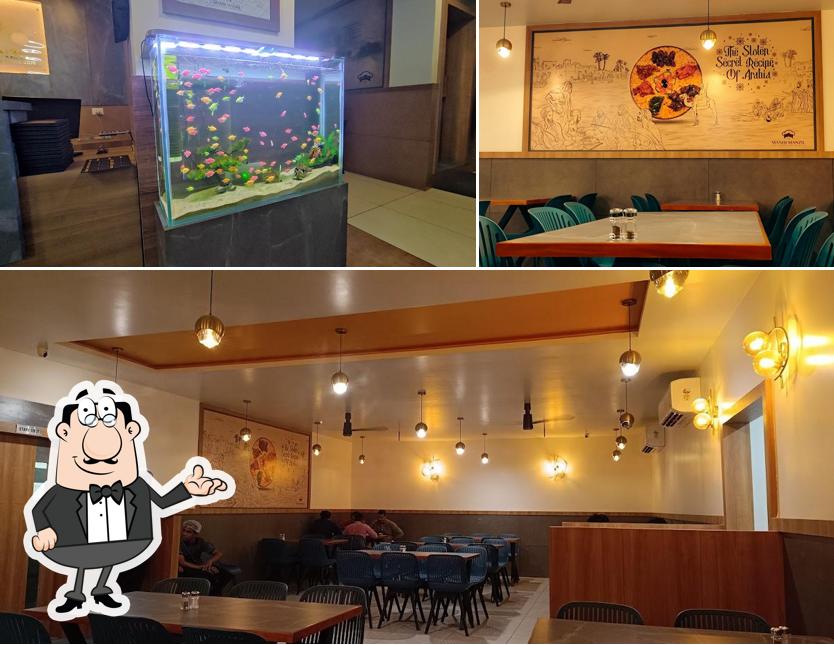 Take a seat at one of the tables at MANDI MANZIL ULLOOR