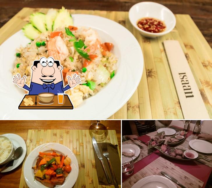 Among different things one can find food and dining table at Isaan Thai Cuisine