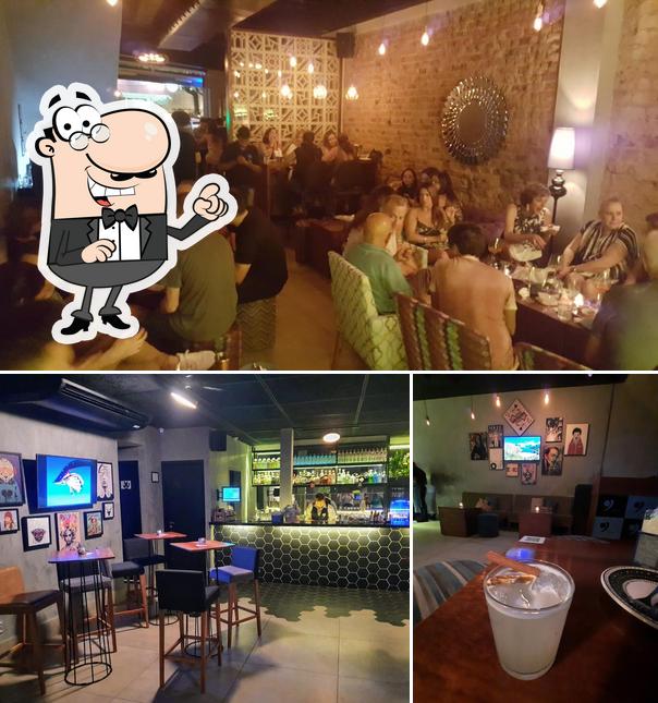 Sente em uma das mesas no Garoa Bar Lounge