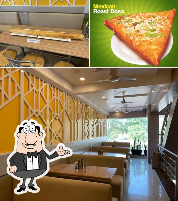 Check out the picture displaying interior and pizza at Shree Krushna Restaurant Dosa Plaza Vegetarian Restaurant