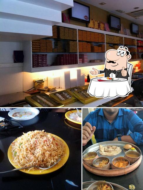 Take a look at the image depicting dining table and interior at Kakada Ramprasad Sweets and Chaats