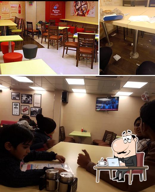 Take a seat at one of the tables at Domino's Pizza Indrapuri Chowk, Hazaribagh