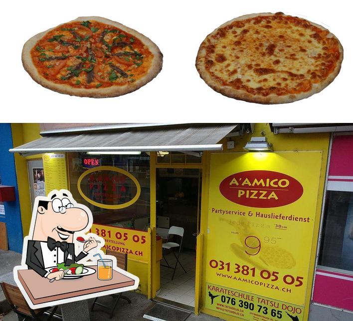 Questa è la immagine che raffigura la cibo e interni di A' Amico Pizza GmbH