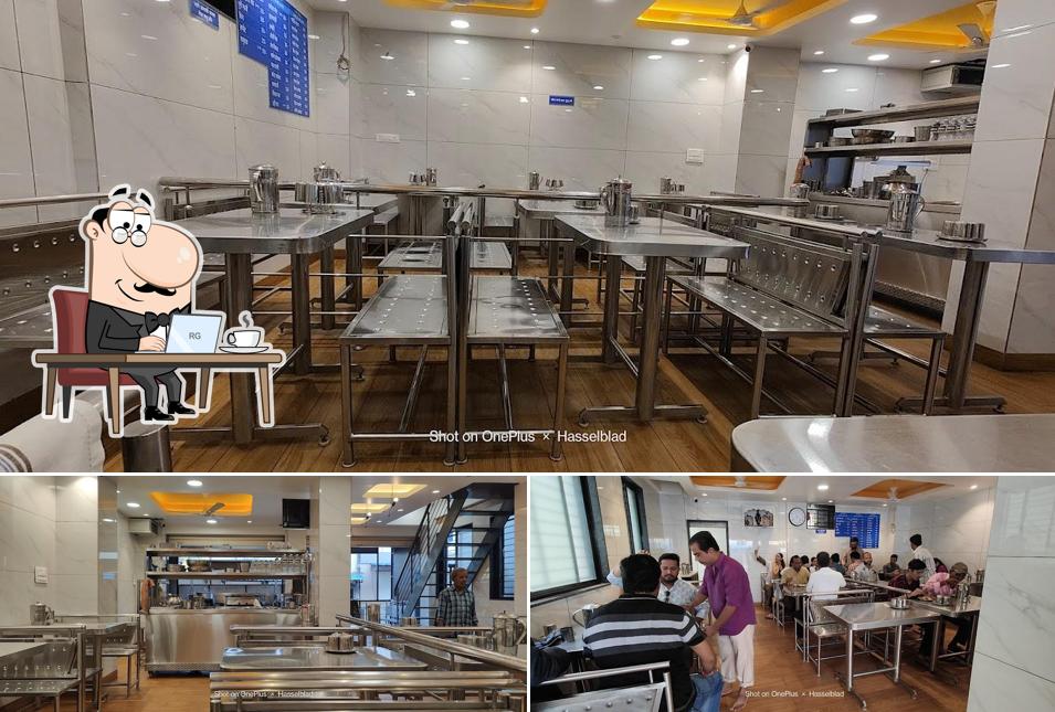 Take a seat at one of the tables at Sangam Idli Gruh And Bhel House