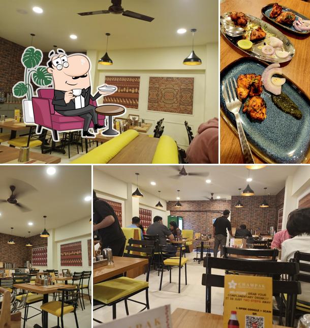 Take a seat at one of the tables at CHAMPAK - Champaran The best North Indian restaurant in Bangalore