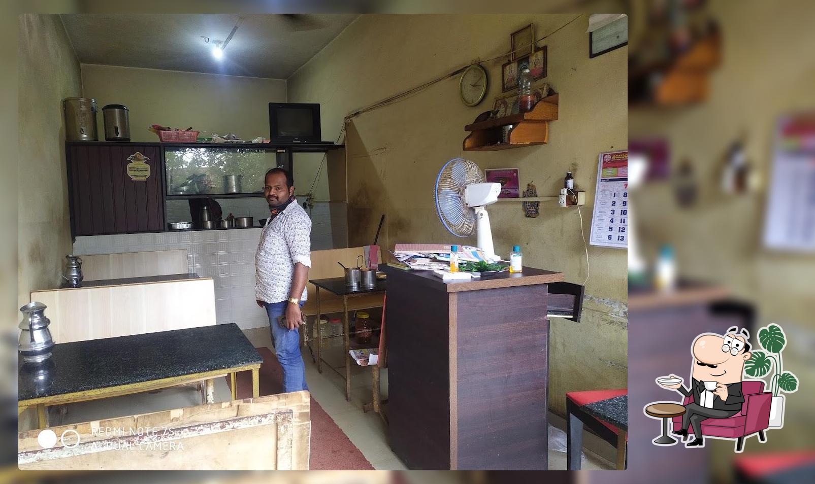 Take a seat at one of the tables at Rathnashree canteen ರತ್ನಶ್ರೀ ಕ್ಯಾಂಟೀನ್