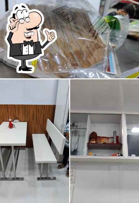 Take a look at the picture showing interior and food at Ambika Sandwich House