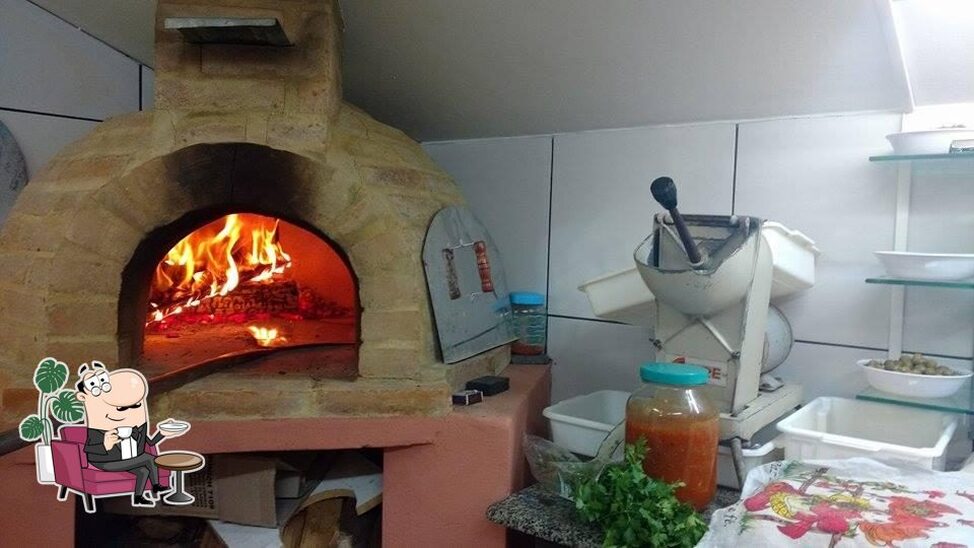 Sente em uma das mesas no Toca da Índia Pizzaria.