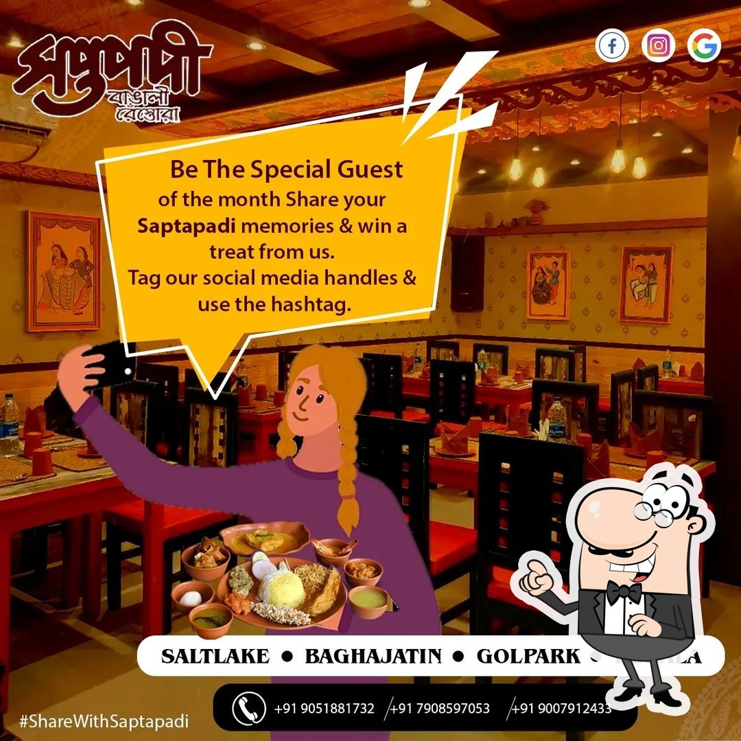 Take a seat at one of the tables at Saptapadi Restaurant.