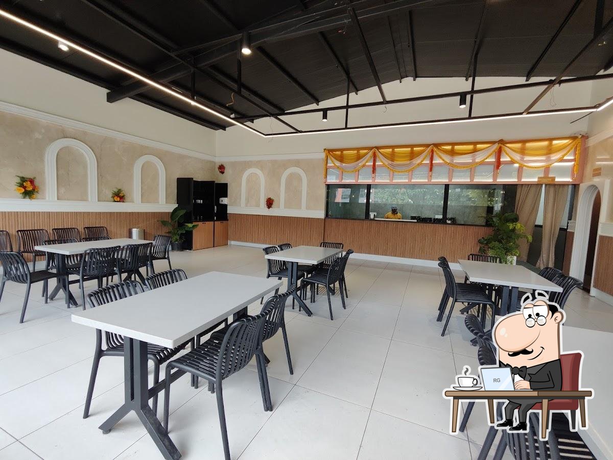 Take a seat at one of the tables at Babai Tiffins, HSR Layout.