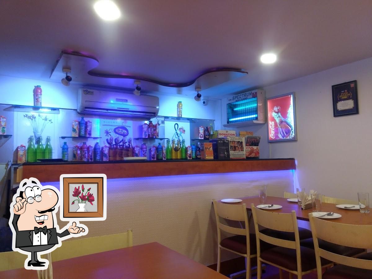 Take a seat at one of the tables at Bhojohori Manna.