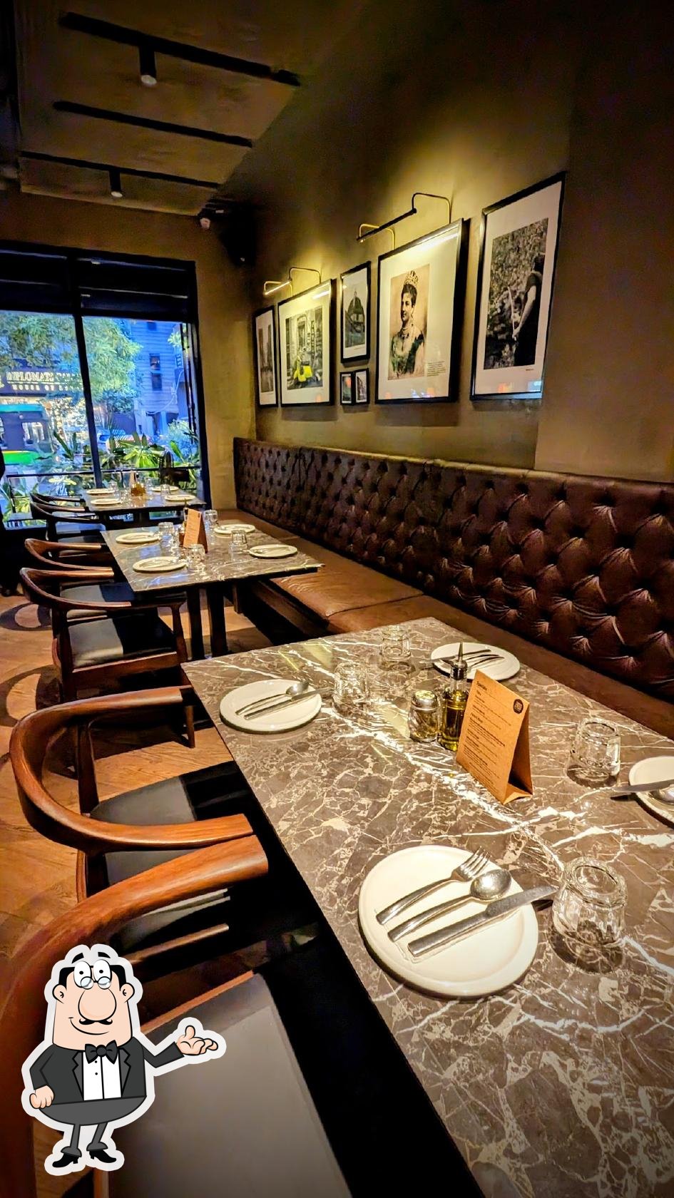 Take a seat at one of the tables at EVOO - Delhi.