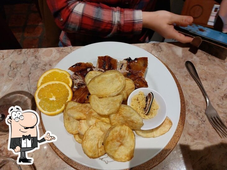 Sente em uma das mesas no Restaurante O Parque Dos Leitões.