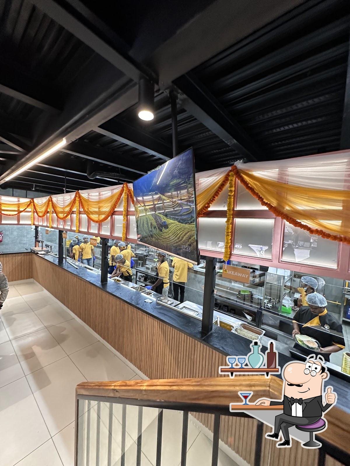 Take a seat at one of the tables at Babai Tiffins, HSR Layout.
