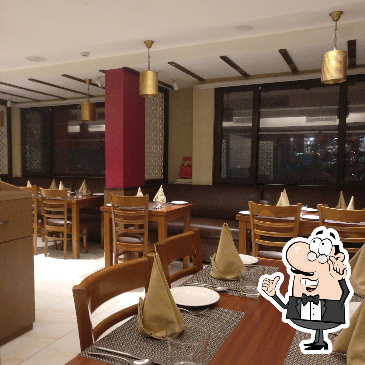 Take a seat at one of the tables at Singh Sahib Best Restaurant in Dwarka.
